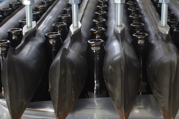 amber glass bottles being processed through a depalletizer