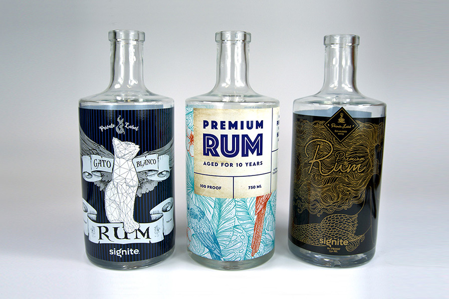 three rum bottles with Signite labelling decorations